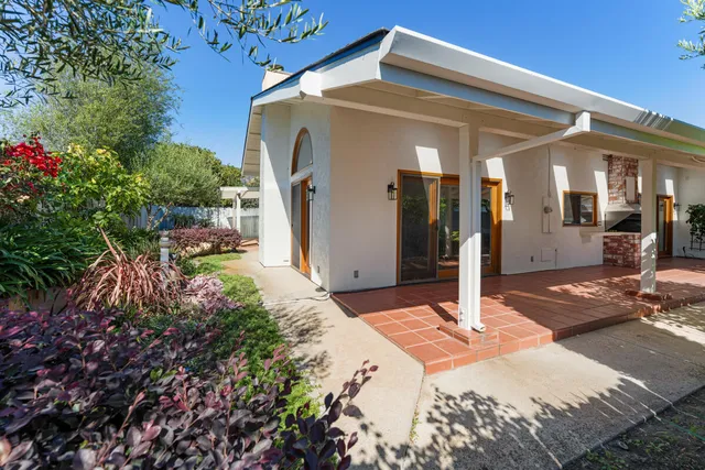 a dining room with furniture and garden view