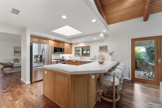 a kitchen with a refrigerator stove and sink