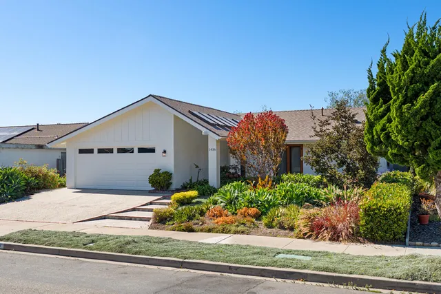 front view of a house with a bench