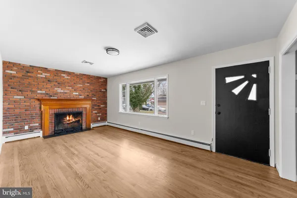 wooden floor fireplace and windows in a room