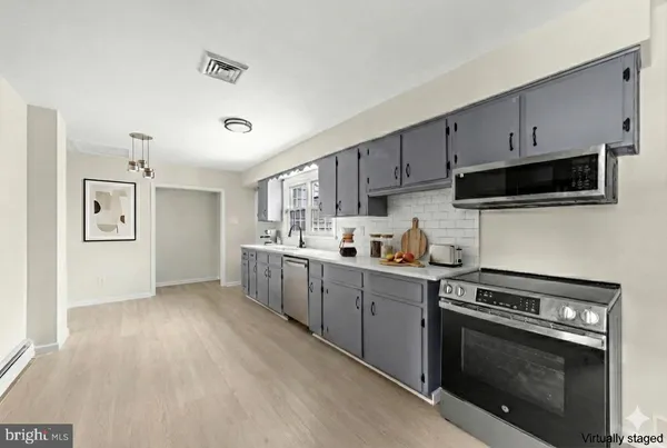 a kitchen with a sink cabinets and stainless steel appliances