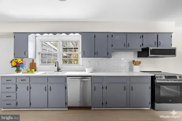 a kitchen with a sink cabinets and window
