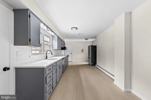 a kitchen with a sink and a refrigerator
