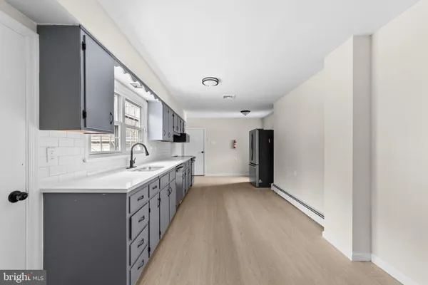 a kitchen with a sink and a refrigerator