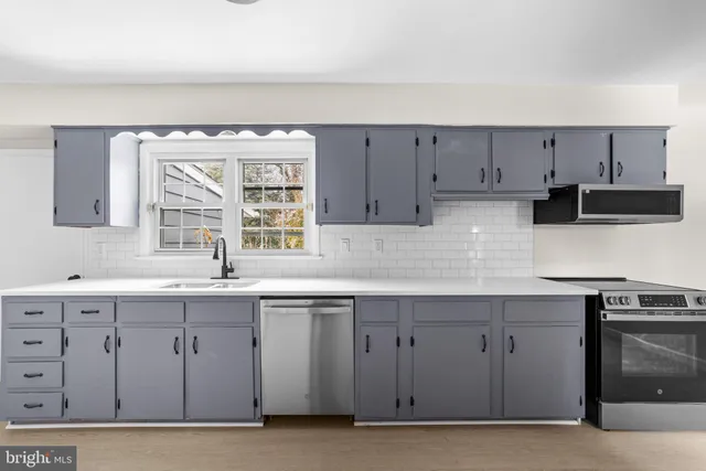 a kitchen with a sink cabinets and window