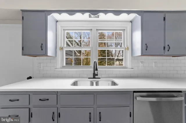 a sink with white cabinets