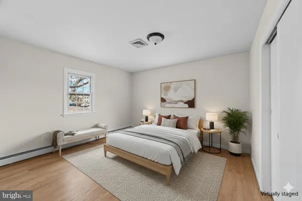 a bedroom with a bed and a potted plant