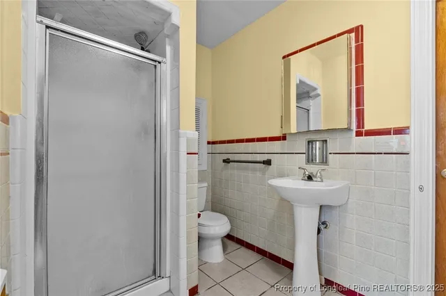 a bathroom with a sink toilet and mirror