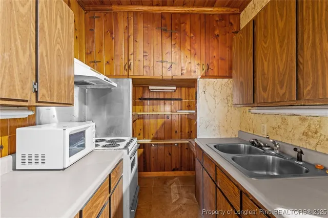 a kitchen with a sink and a refrigerator