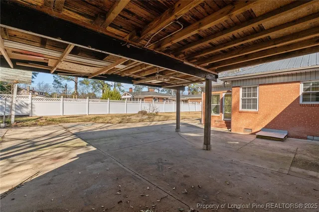 a view of a yard with plants and trees