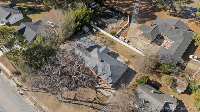 an aerial view of a house with a yard