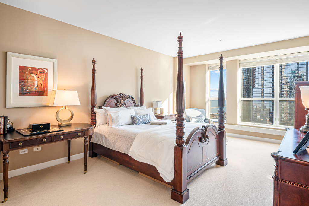 445 East North Water Street, Unit 2003 Chicago, IL 60611 - Photo 5 of 18 a bedroom with a bed and a night stand