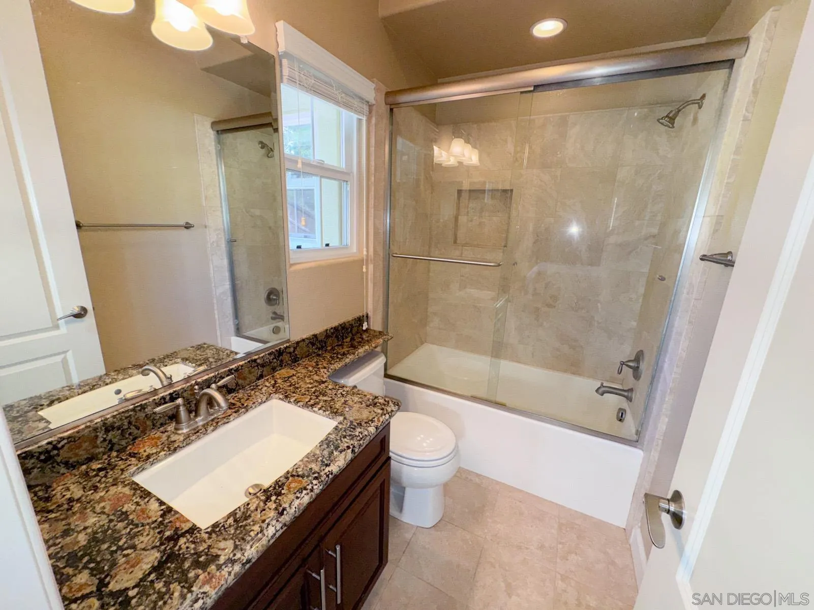 536 Quail Pointe Lane Encinitas, CA 92024 - Photo 23 of 28 a bathroom with a granite countertop sink a toilet and shower