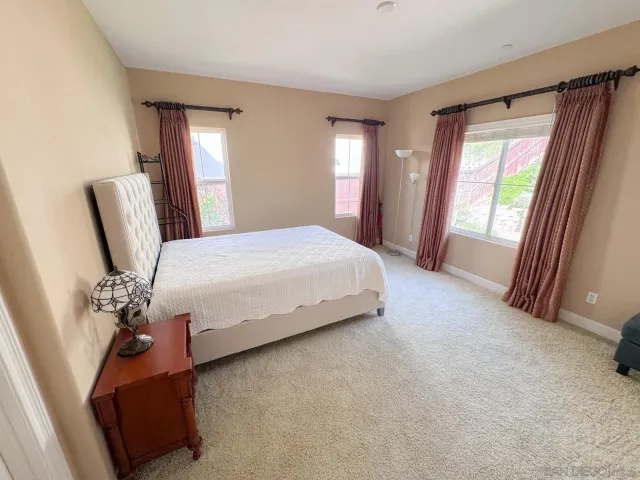 a bedroom with a bed couch and a window