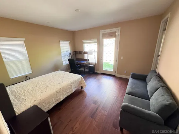 a bedroom with a bed couch and a window