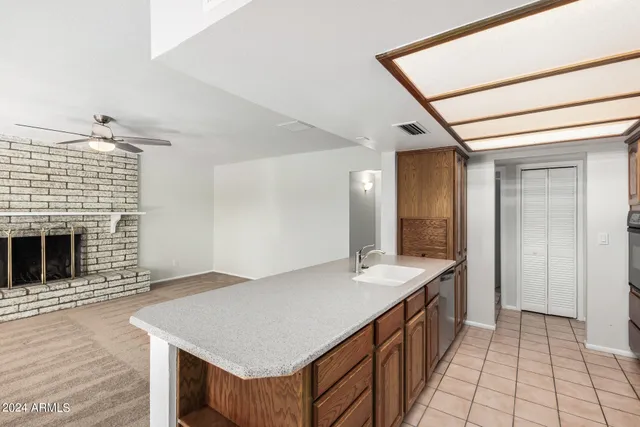 a kitchen with stainless steel appliances granite countertop a sink and a refrigerator