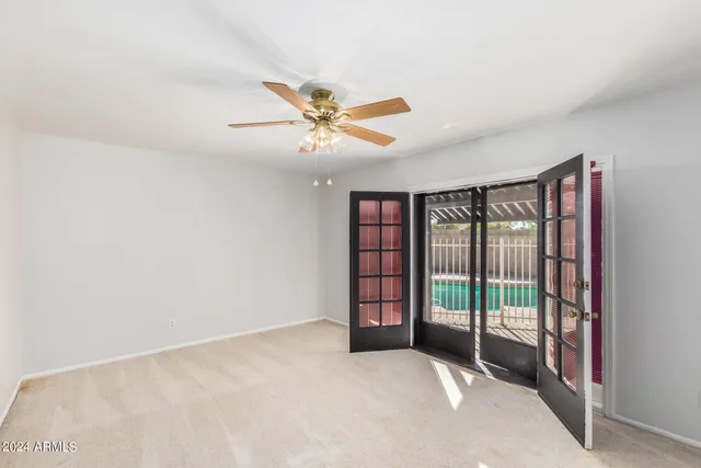 an empty room with a empty space and a ceiling fan