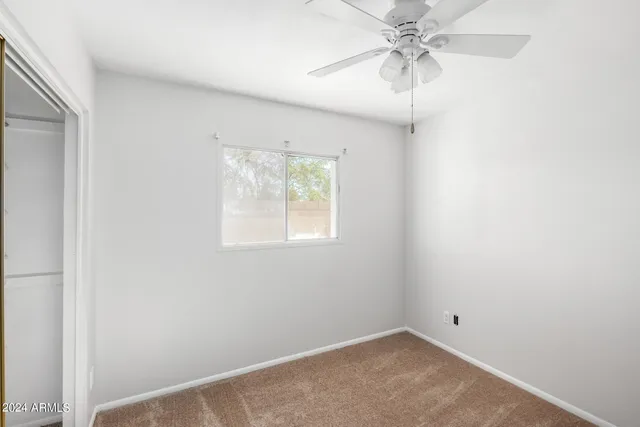 a view of a room with a ceiling fan