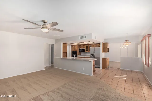 a kitchen with stainless steel appliances kitchen island granite countertop a refrigerator and a sink