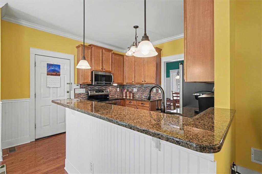 101 Oscar Lane Dallas, GA 30132 - Photo 15 of 55 a kitchen with kitchen island granite countertop a sink a counter top space and cabinets