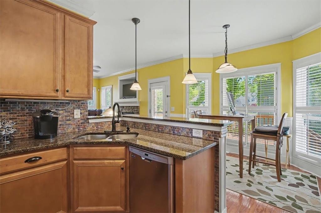 101 Oscar Lane Dallas, GA 30132 - Photo 17 of 55 a kitchen with stainless steel appliances granite countertop a sink a stove and a wooden floors
