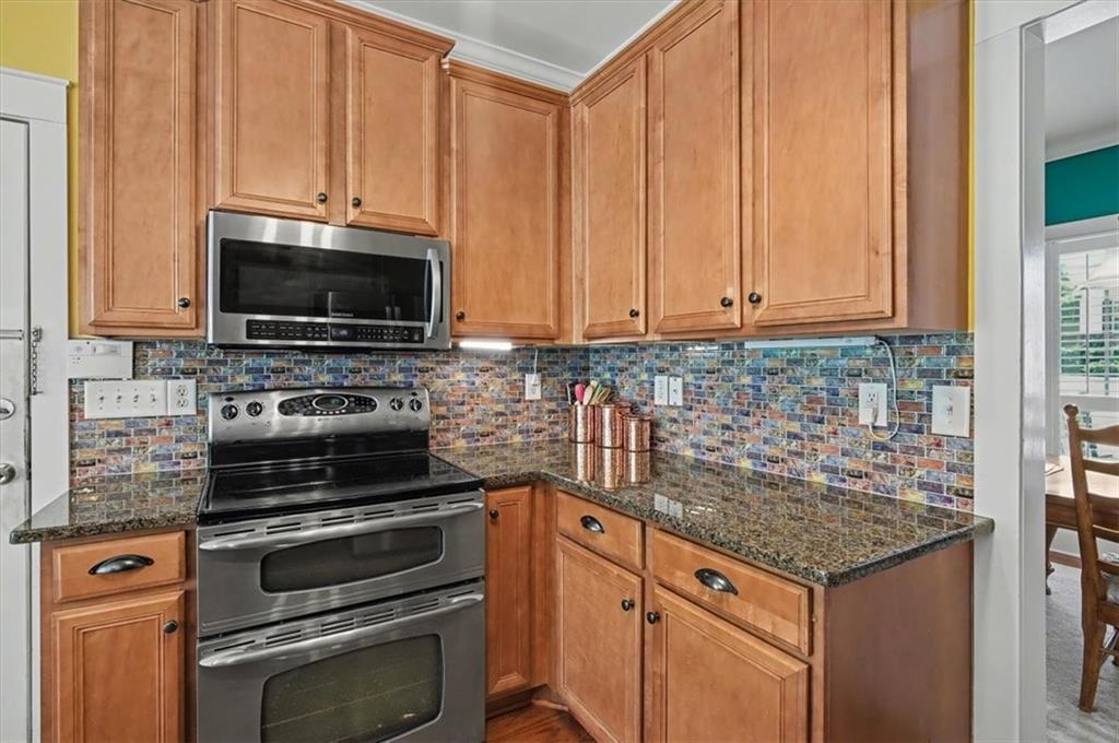 101 Oscar Lane Dallas, GA 30132 - Photo 18 of 55 a kitchen with granite countertop a stove microwave and sink