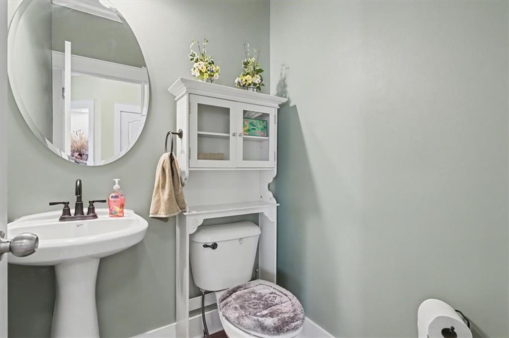 101 Oscar Lane Dallas, GA 30132 - Photo 21 of 55 a bathroom with a sink a mirror and a toilet