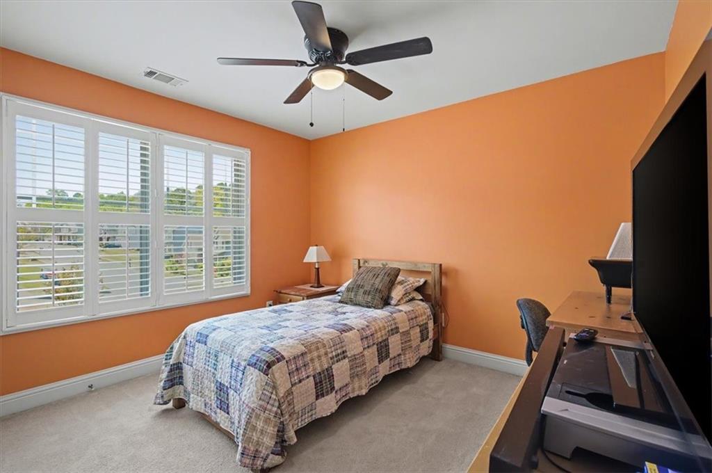 101 Oscar Lane Dallas, GA 30132 - Photo 22 of 55 a bedroom with a bed and a chandelier