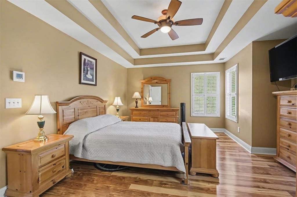 101 Oscar Lane Dallas, GA 30132 - Photo 27 of 55 a bedroom with a large bed a flat tv screen and dresser