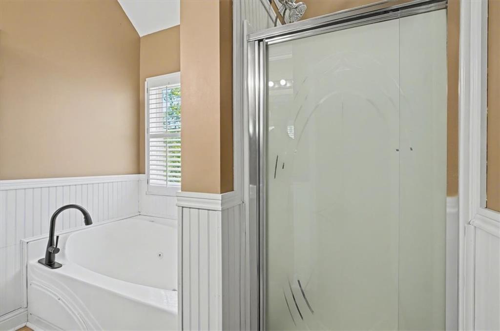 101 Oscar Lane Dallas, GA 30132 - Photo 30 of 55 a bathroom with a bathtub and shower