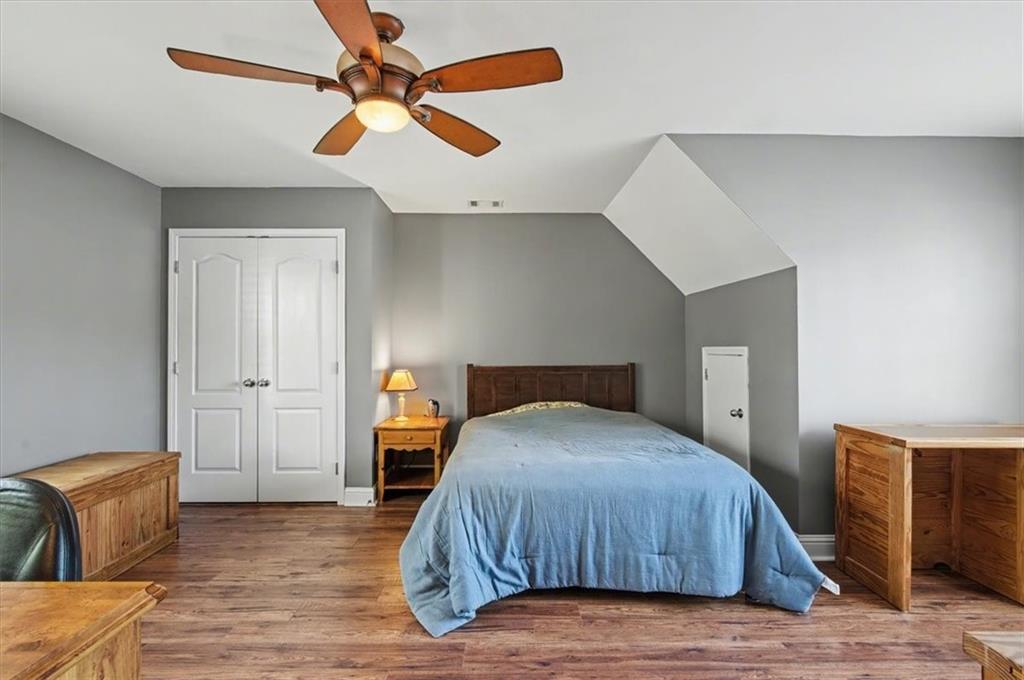 101 Oscar Lane Dallas, GA 30132 - Photo 33 of 55 a bedroom with a bed and wooden floor