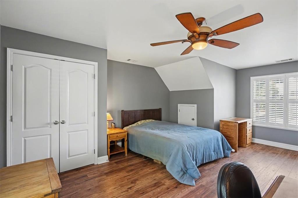 101 Oscar Lane Dallas, GA 30132 - Photo 34 of 55 a bedroom with a bed and wooden floor