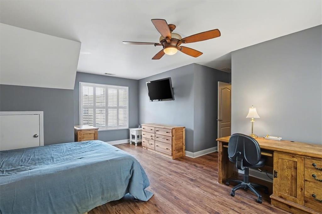 101 Oscar Lane Dallas, GA 30132 - Photo 35 of 55 a bedroom with a bed and wooden floor