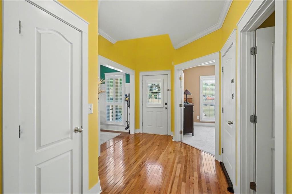 101 Oscar Lane Dallas, GA 30132 - Photo 6 of 55 a view of a hallway with wooden floor and a bathroom