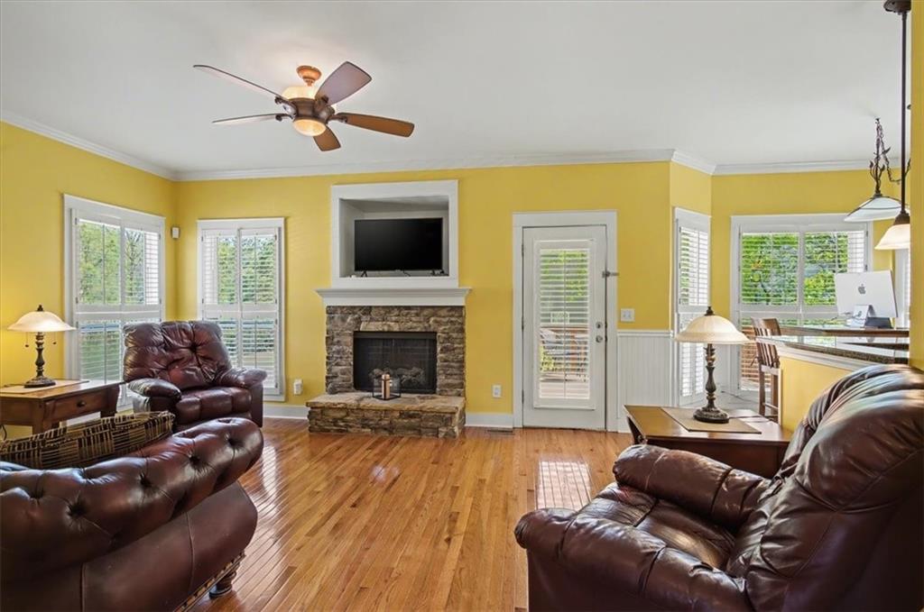 101 Oscar Lane Dallas, GA 30132 - Photo 10 of 55 a living room with furniture a fireplace a flat screen tv and a large window