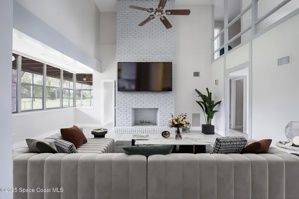 a living room with furniture a flat screen tv and a fireplace