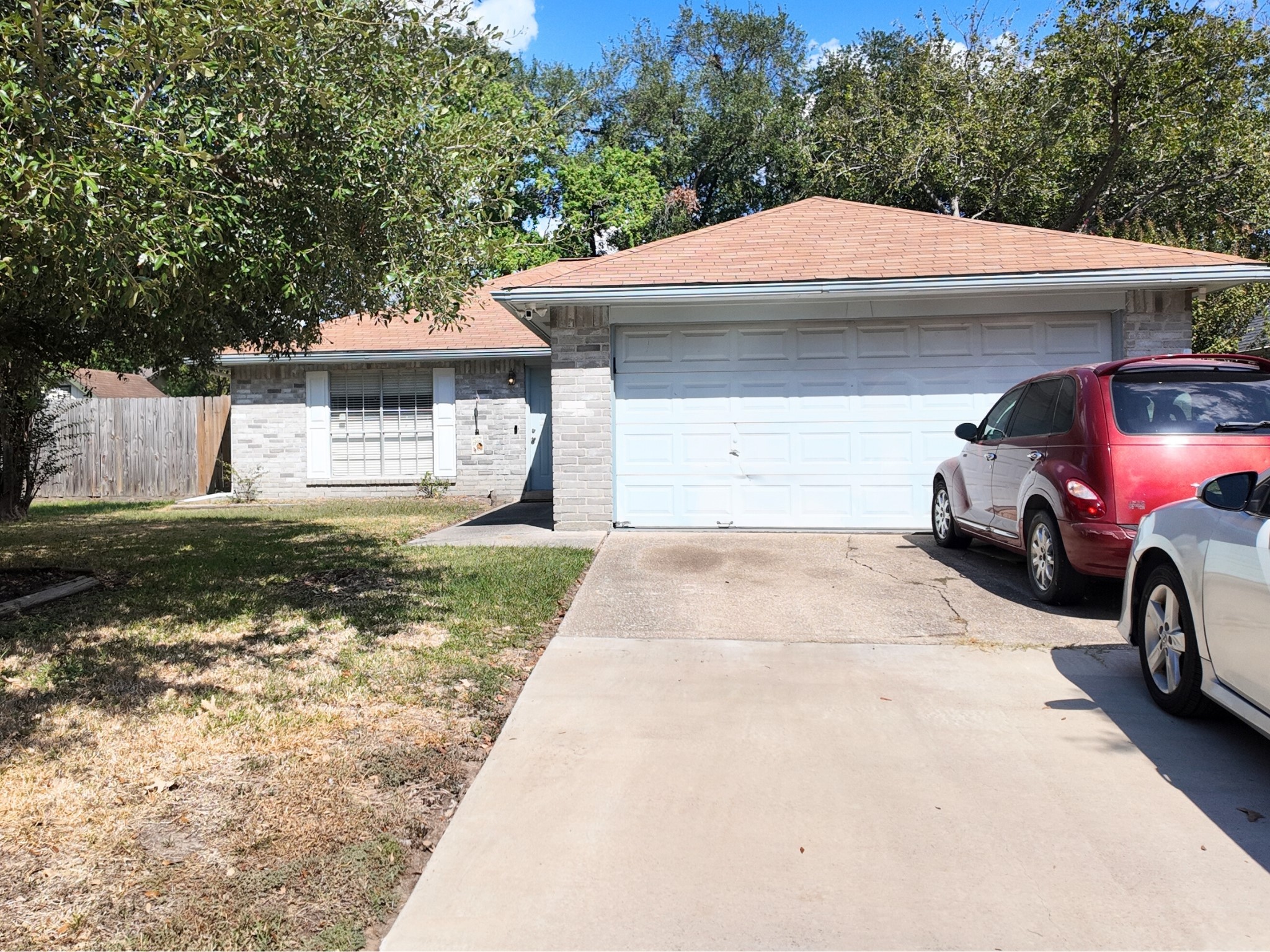 10070 Green Valley Lane Houston, TX 77064 - Photo 2 of 27 a front view of a house with a garden and parking space