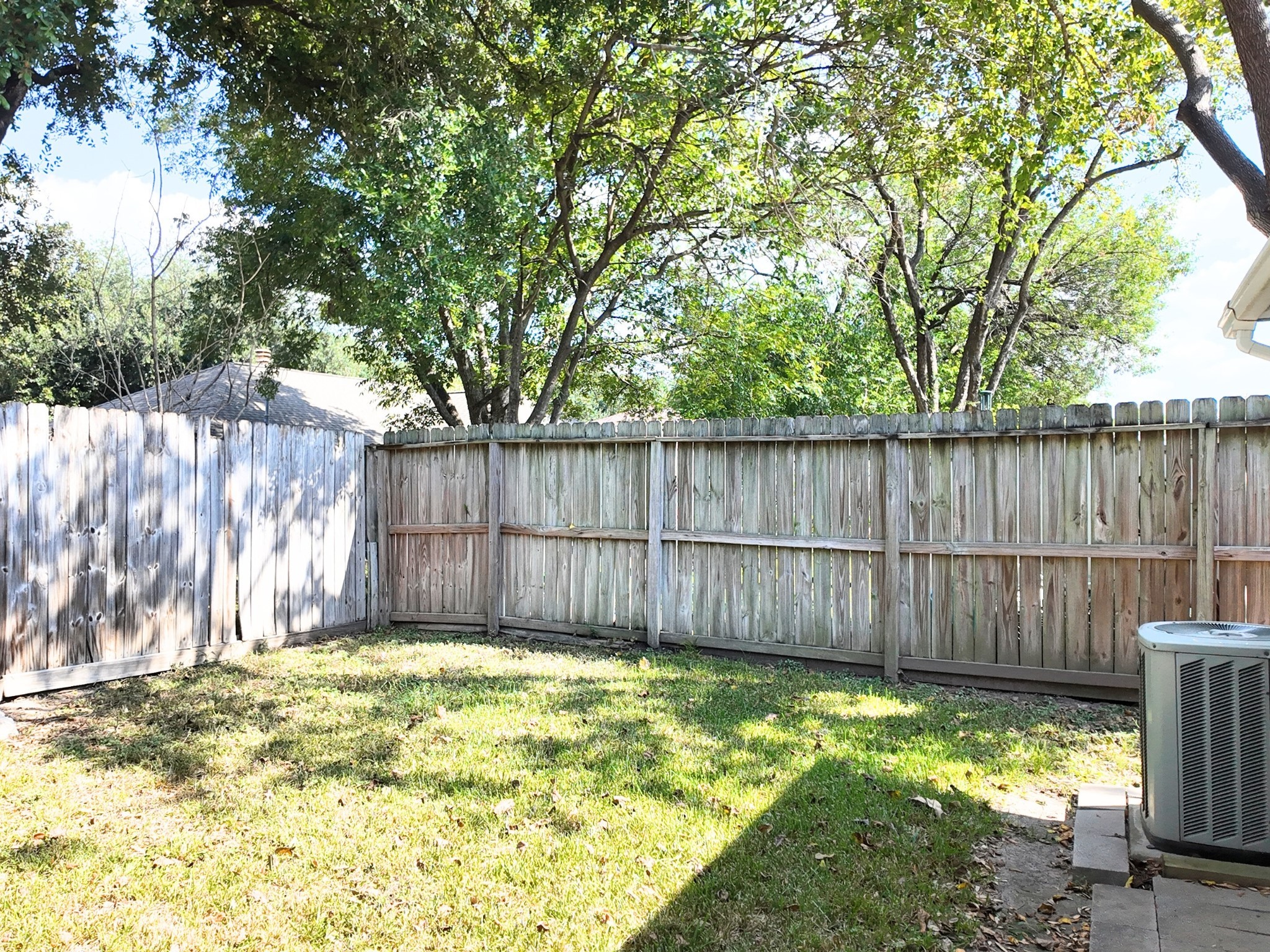 10070 Green Valley Lane Houston, TX 77064 - Photo 25 of 27 a view of a backyard with a trees and a fence
