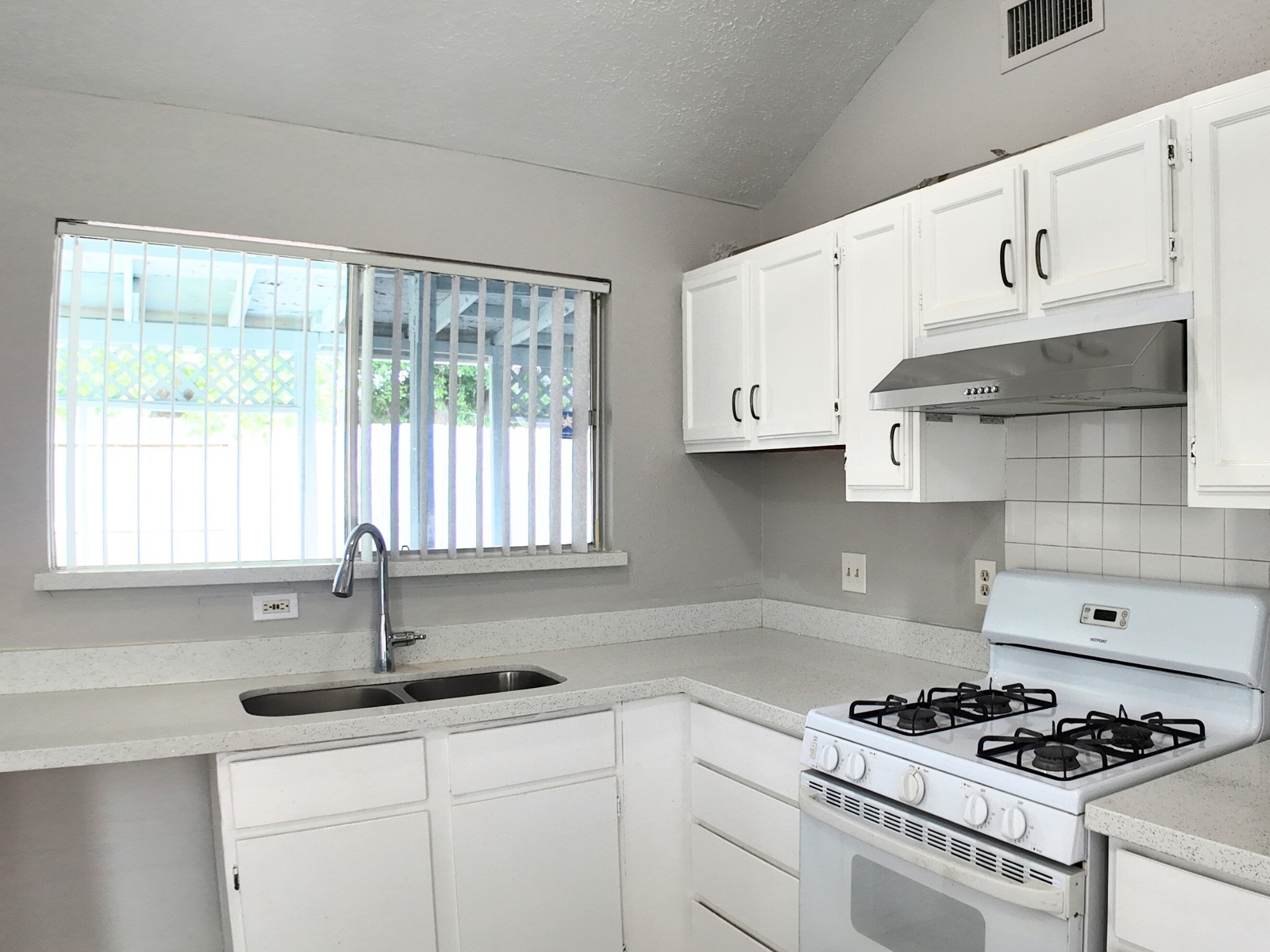 10070 Green Valley Lane Houston, TX 77064 - Photo 9 of 27 a kitchen with stainless steel appliances granite countertop a sink a stove and a granite counter tops