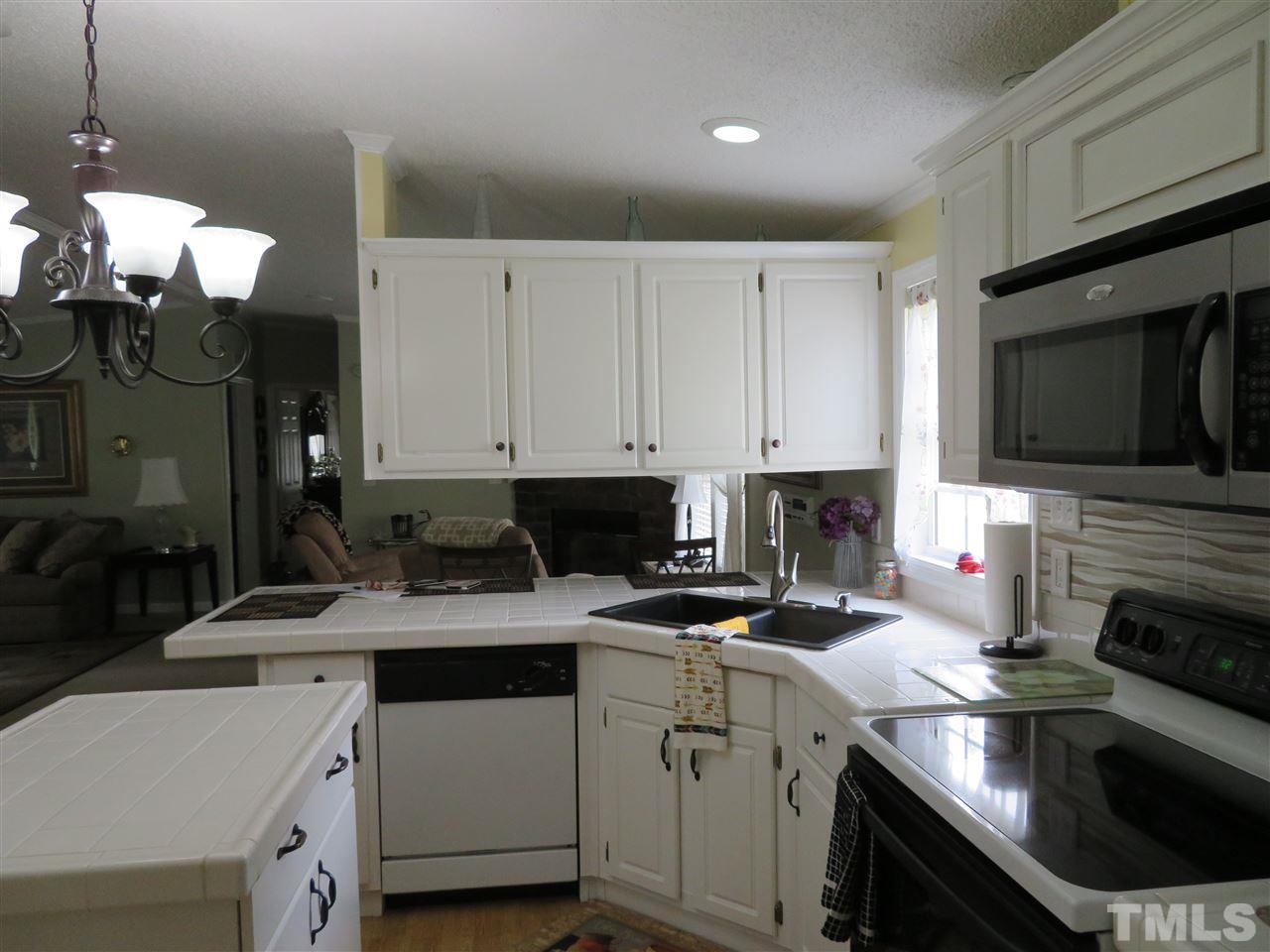 4481 Pixley Pritchard Road Timberlake, NC 27583 - Photo 11 of 25 a kitchen with a sink stove and microwave
