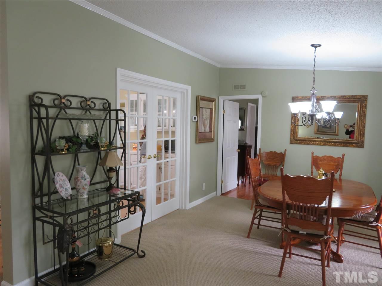 4481 Pixley Pritchard Road Timberlake, NC 27583 - Photo 13 of 25 a view of a dining room with furniture and chandelier