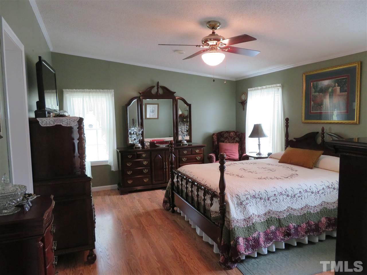 4481 Pixley Pritchard Road Timberlake, NC 27583 - Photo 16 of 25 a bedroom with a bed and dresser with mirror