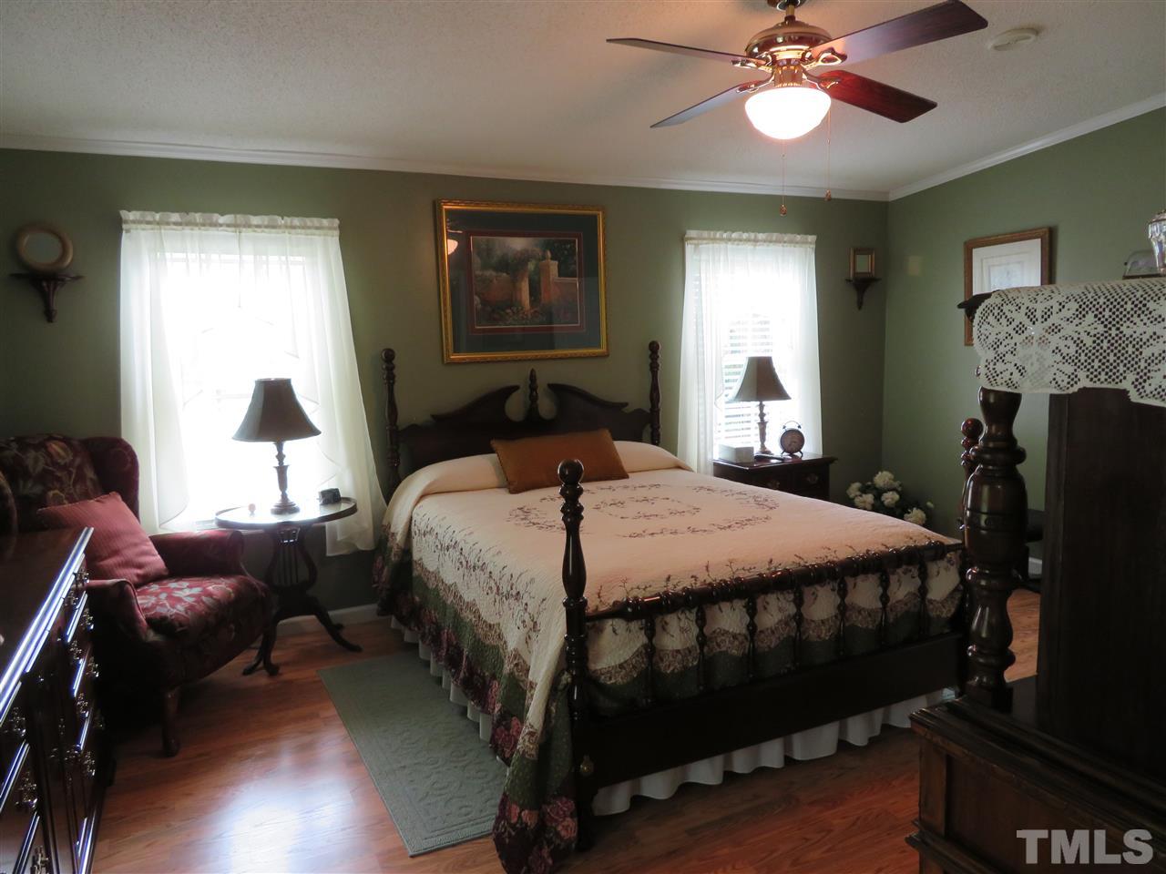 4481 Pixley Pritchard Road Timberlake, NC 27583 - Photo 17 of 25 a bedroom with a bed wooden floor and window