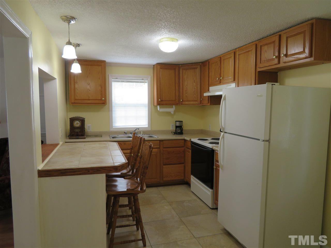 4481 Pixley Pritchard Road Timberlake, NC 27583 - Photo 21 of 25 a kitchen with a refrigerator sink and cabinets