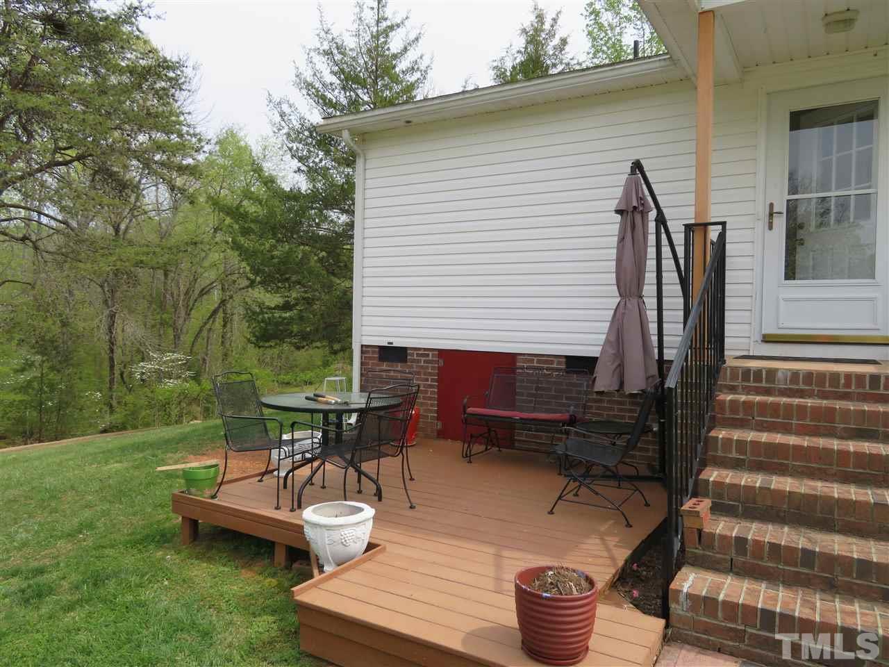 4481 Pixley Pritchard Road Timberlake, NC 27583 - Photo 4 of 25 a view of a patio with a table and chairs