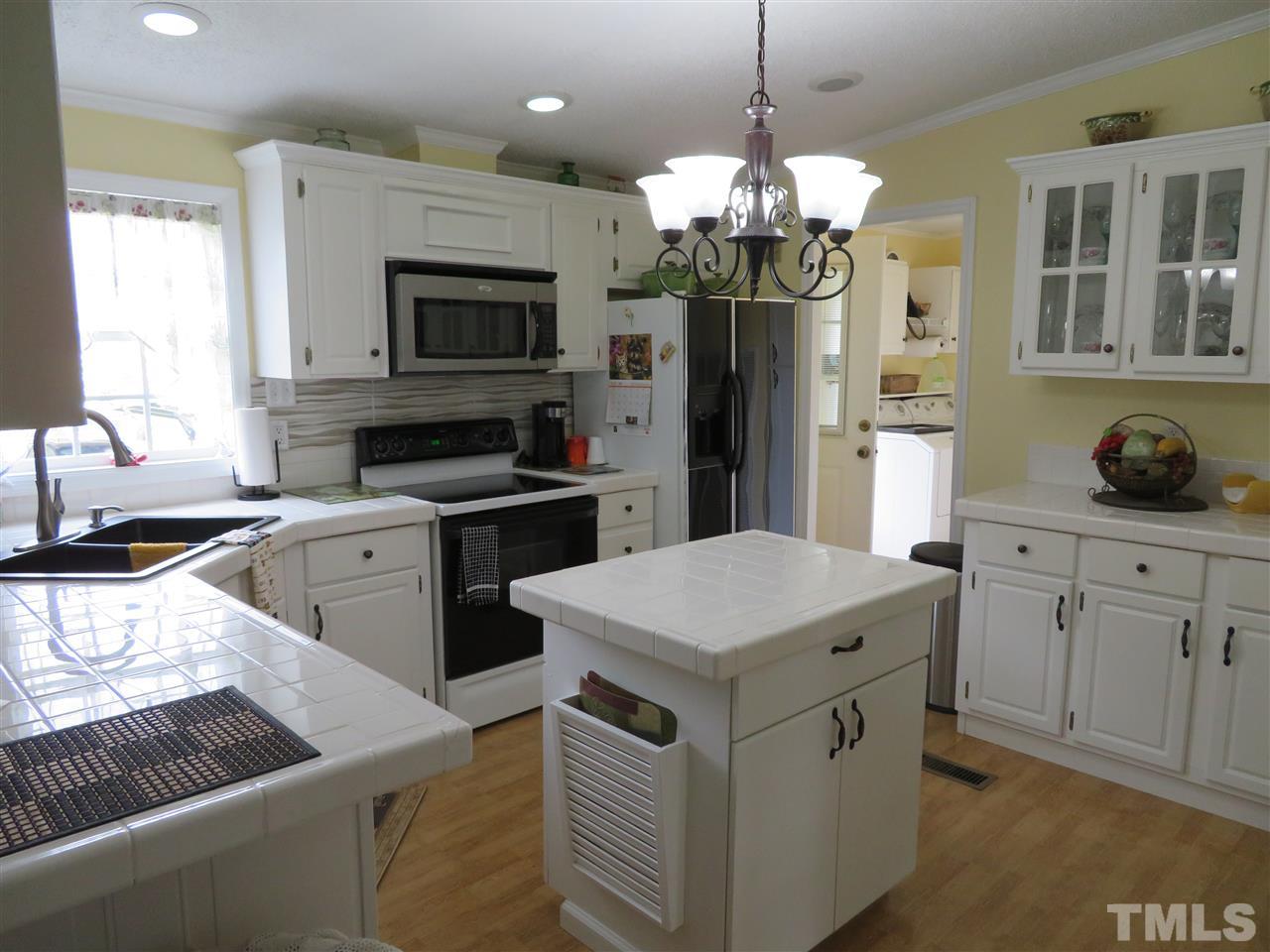 4481 Pixley Pritchard Road Timberlake, NC 27583 - Photo 8 of 25 a kitchen that has a lot of white cabinets and stainless steel appliances