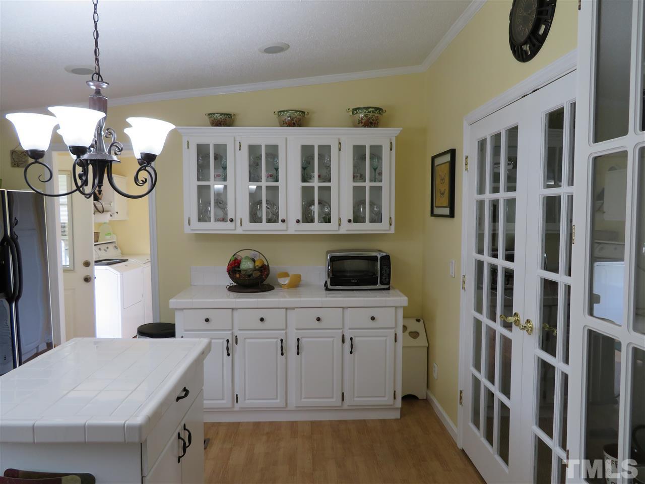 4481 Pixley Pritchard Road Timberlake, NC 27583 - Photo 9 of 25 a kitchen with cabinets and outdoor seating