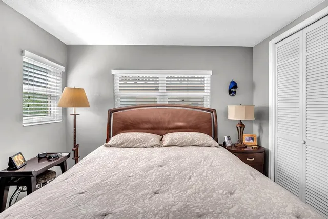 a bedroom with a bed and window