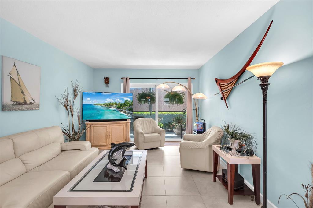 2131 Northeast 42nd Court, Unit 104E Lighthouse Point, FL 33064 - Photo 19 of 31 a living room with furniture and a large window