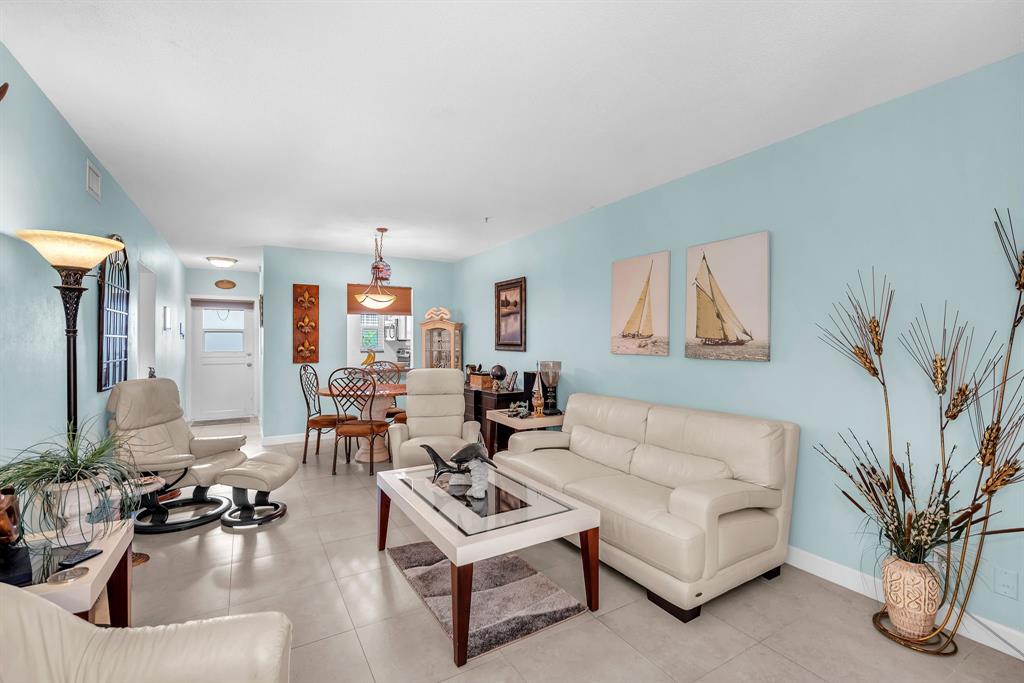 2131 Northeast 42nd Court, Unit 104E Lighthouse Point, FL 33064 - Photo 20 of 31 a living room with furniture and a potted plant